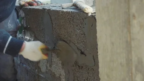 Construction worker builds brick wall, closeup view at construction site Stock Footage 83102355