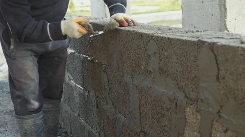 Construction worker builds brick wall, closeup view at construction site Stock Footage 83102898