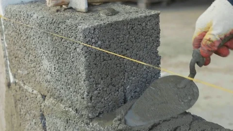 Construction worker builds brick wall, closeup view at construction site Stock Footage 83114028