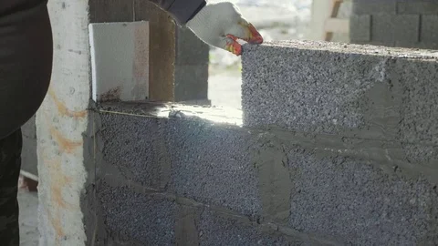 Construction worker builds brick wall, closeup view at construction site Stock Footage 83197366
