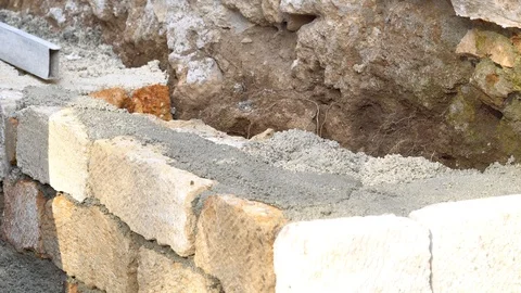 Construction worker builds brick wall, closeup view at construction site. Stock Footage 85960302