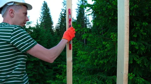 Construction worker builds a house using water level. Video stock 198722263