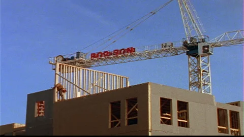 Construction worker builds wall -crane behind Stock Footage 145617689