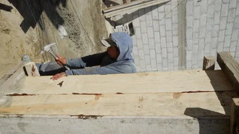 Construction worker in is busy at the unfinished building. 스톡 동영상 232083085