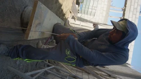 Construction worker in is busy at the unfinished building. 스톡 동영상 232083110