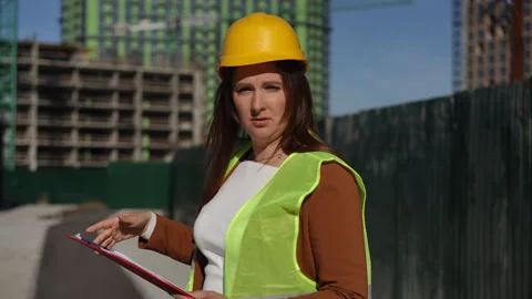 Construction worker is carefully assessing the project on site focused on detais Stock Footage 311858096