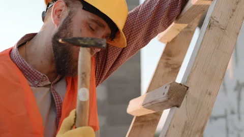 Construction worker carefully inspecting and preparing a ladder Video stock 286049864