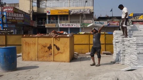 Construction worker carries stone slab on head Stock Footage 83635356