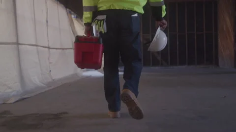 Construction Worker Carrying Toolbox On Job Site Видео 270390180