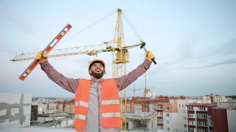 Construction worker celebrates success on a high-rise site in the city Video stock 286052668