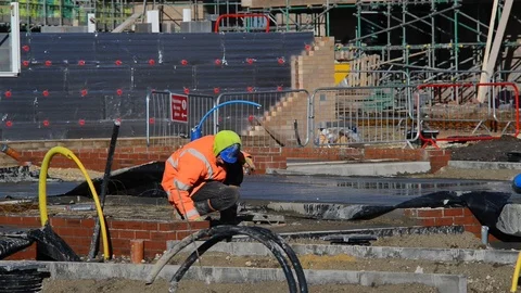 Construction worker cementing around bricks on new house build uk Stock Footage 85926840