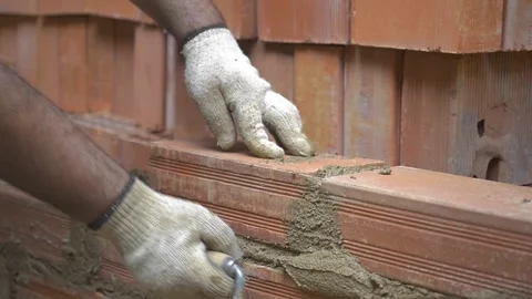 Construction worker cementing brick wall Stock Footage 255684382