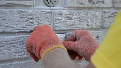 Construction worker check the level of insulation sheets on house facade wall Stock-Footage 194313621
