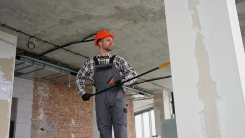 Construction worker checking plaster on walls and ceilings Stock Footage 314556863