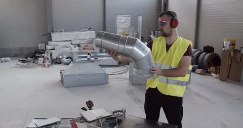 A construction worker, checks a sewer pipe. The tools and equipment are reviewed Stock Footage 126911221