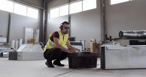 A construction worker, checks a sewer pipe. The tools and equipment are reviewed Stock Footage 127035022