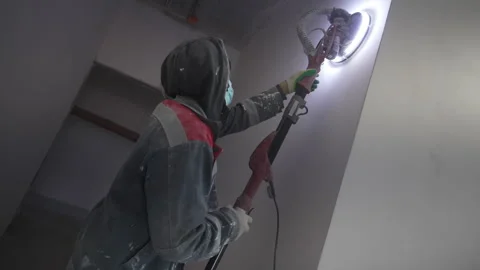 Construction worker checks smoothness of interior wall Stock Footage 309767264