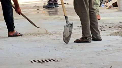 A construction worker, clad in practical workwear, is captured mid-action Video stock 311884266