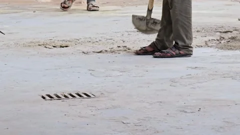 A construction worker, clad in practical workwear, is captured mid-action 스톡 동영상 311884297