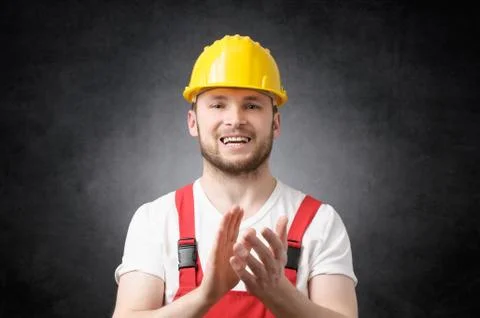 Construction worker clapping his hands Stock Photos