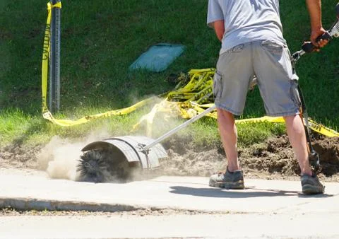 Construction worker cleaning the road dust Stock Photos