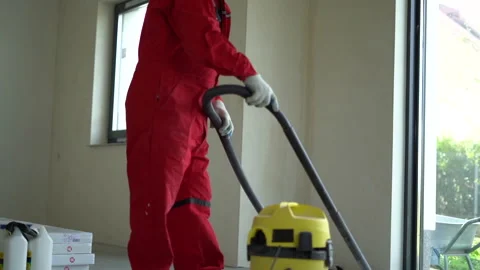 Construction worker cleans a building site with a industrial vacuum cleaner Stock Footage 163832403
