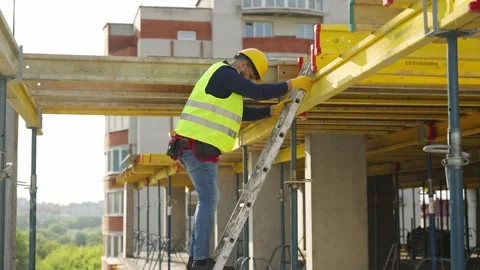 Construction worker climbing a ladder on building site Stock-Footage 343449520