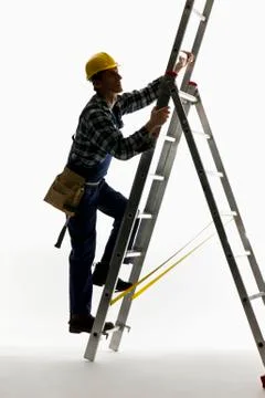 A construction worker climbing a ladder Stock Photos