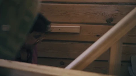 A construction worker is climbing up the stairs and is holding bricks in his Stock Footage 90086533