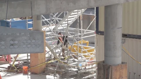 Construction worker climbing temporary stair structure Stock Footage 81449278