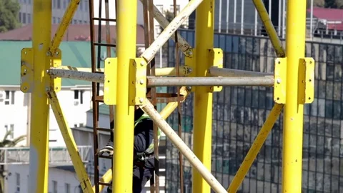 Construction worker climbs the ladder to the crane Video stock 75228054