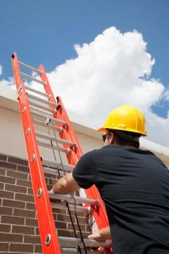 Construction Worker Climbs Ladder Stock Photos