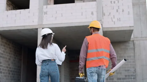 Construction worker collaborates on building site with engineer Video stock 295956789