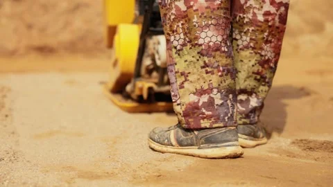 Construction worker compacting sand with vibrating plate Stock Footage 341294794