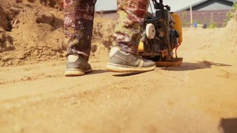Construction worker compacting sand with vibratory plate Stock Footage 341294869