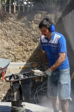Construction worker compacting soil using compactor. Work with tamping machin Stock Photos