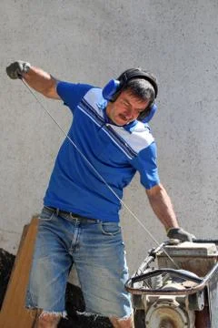 Construction worker compacting soil using compactor. Work with tamping machin Stock Photos