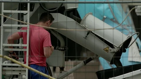 Construction worker at a concrete mixer, close up Stock Footage 82446984