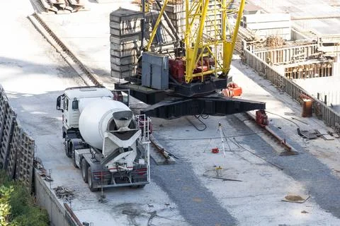 Construction worker Concrete pouring during commercial concreting floors of Stock Photos