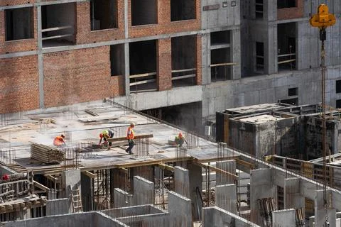 Construction worker Concrete pouring during commercial concreting floors of Stock Photos