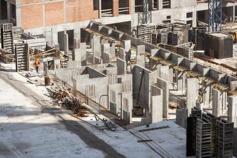 Construction worker Concrete pouring during commercial concreting floors of Stock Photos