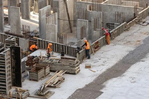 Construction worker Concrete pouring during commercial concreting floors of Stock Photos