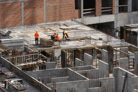 Construction worker Concrete pouring during commercial concreting floors of Stock Photos