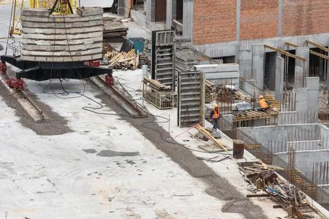 Construction worker Concrete pouring during commercial concreting floors of Stock Photos