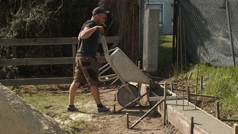 Construction worker concretes a foundation Stock Footage 99899575