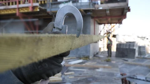 Construction worker connects a safety harness Stock Footage 104746692