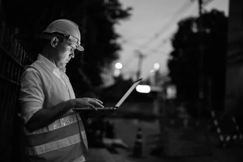 Construction worker at the construction site using laptop computer Stock Photos