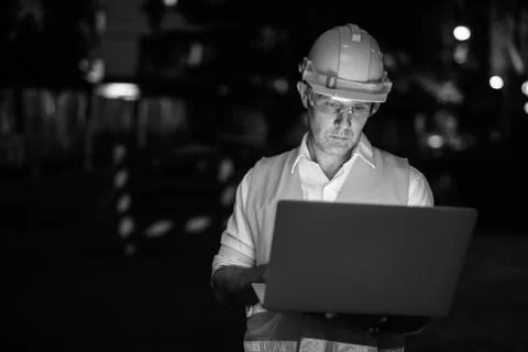 Construction worker at the construction site using laptop computer Stock Photos