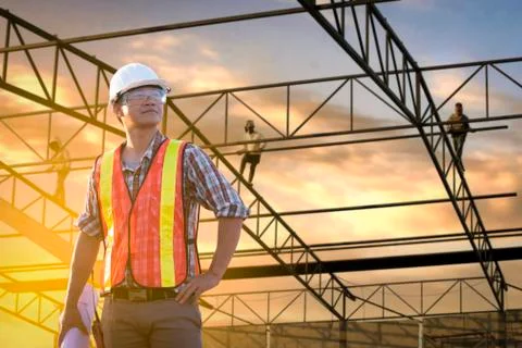 A construction worker control in the construction of roof structures on const Stock Photos