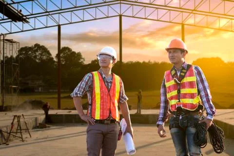 A construction worker control in the construction of roof structures on const Stock Photos